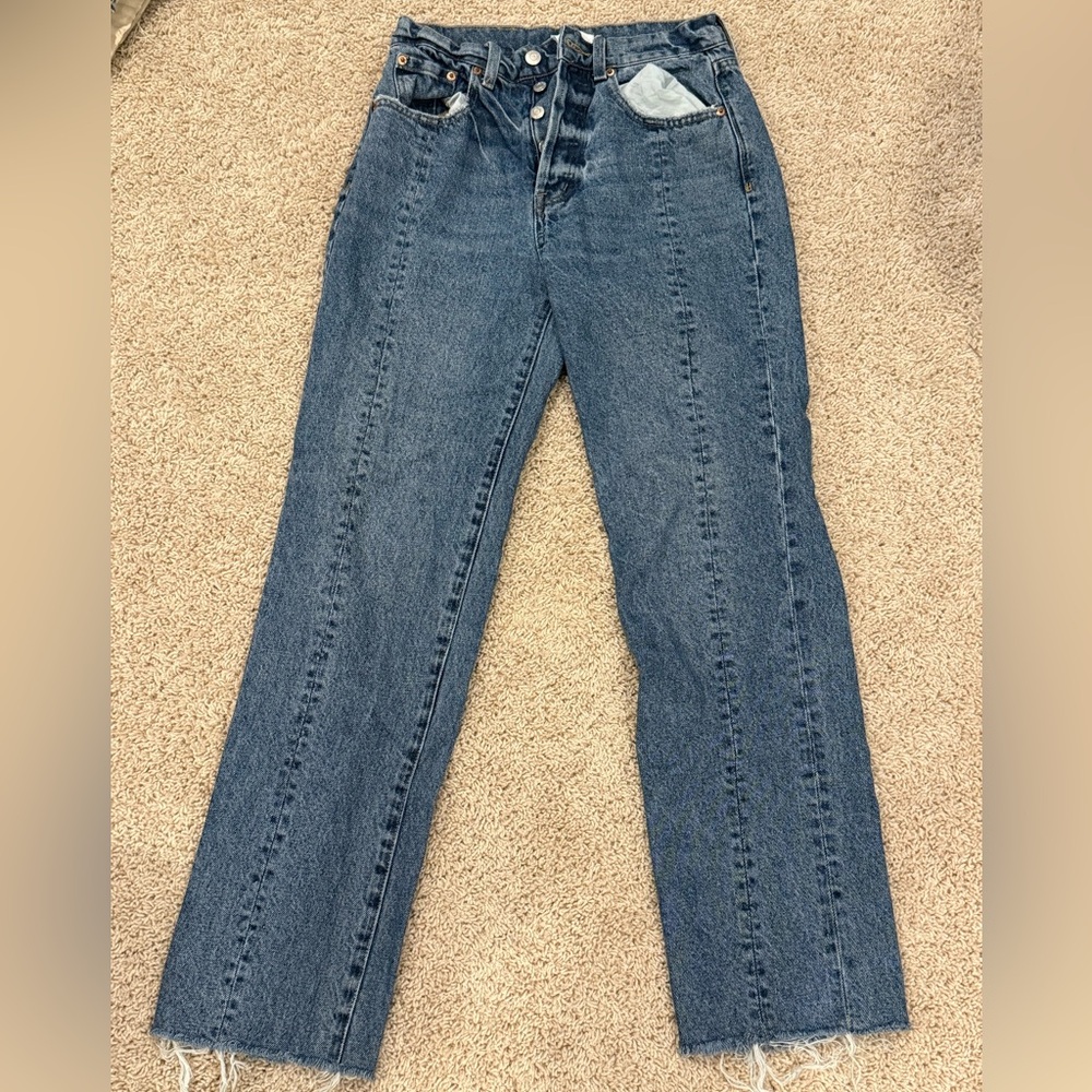 Pistola Size 26 mid-rise straight leg dark jeans with frayed bottoms.